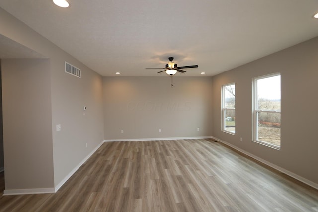 empty room featuring ceiling fan and light wood-type flooring