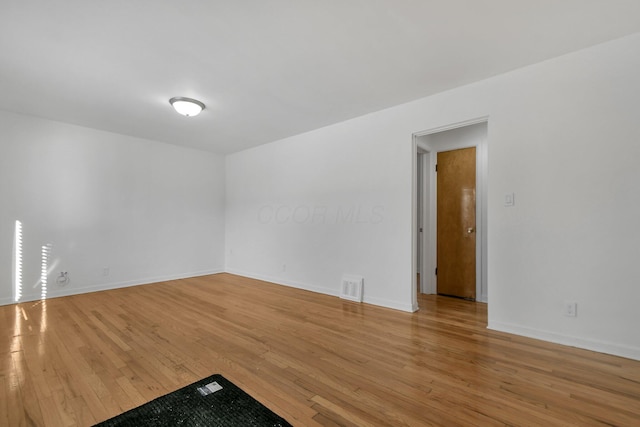 spare room featuring light wood-type flooring