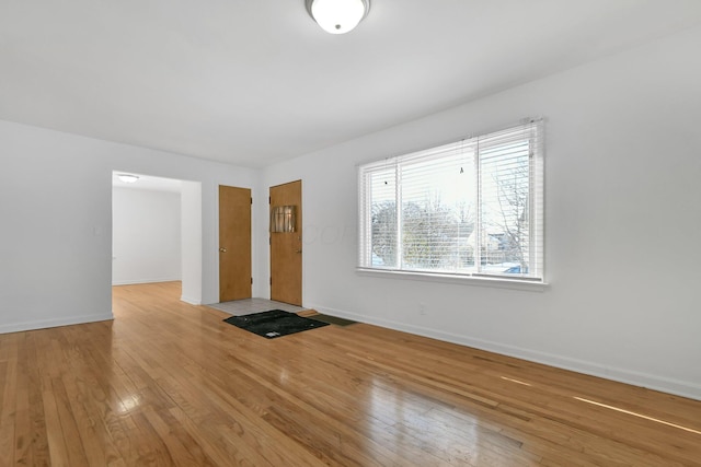 unfurnished room with light hardwood / wood-style flooring