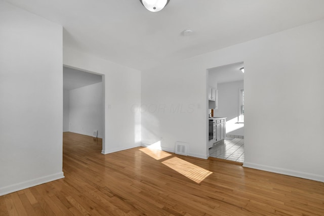 unfurnished room with light wood-type flooring