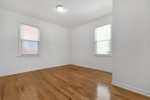 empty room with hardwood / wood-style floors