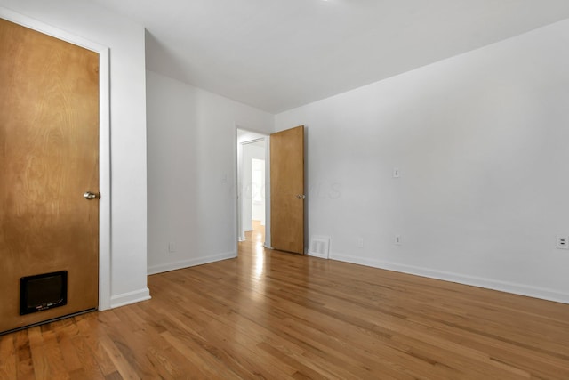 unfurnished room featuring light hardwood / wood-style floors