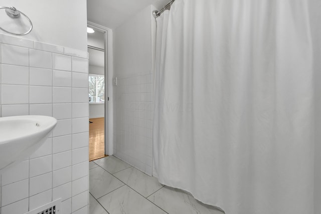 bathroom featuring tile walls and tile patterned flooring