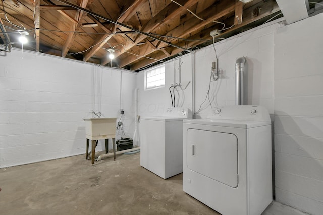 laundry area with washing machine and dryer and sink