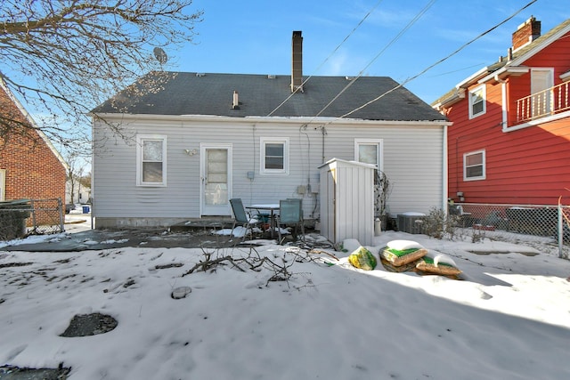 snow covered property featuring central air condition unit