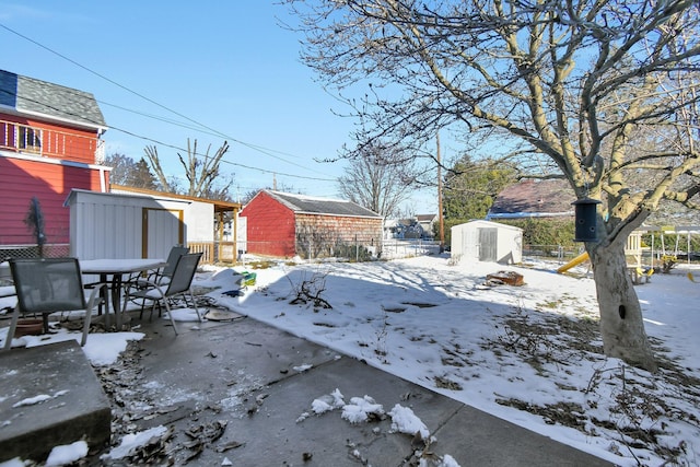 snowy yard with a storage unit