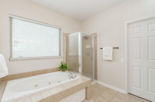 bathroom with independent shower and bath and tile patterned floors