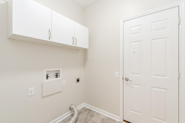 clothes washing area with hookup for a washing machine, cabinets, and hookup for an electric dryer