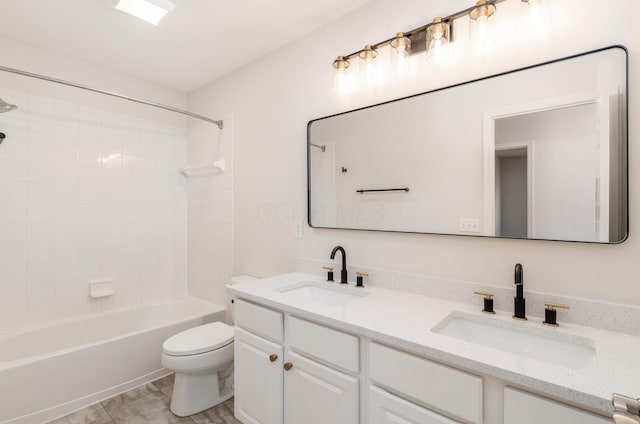 full bathroom featuring vanity, toilet, tile patterned floors, and shower / washtub combination