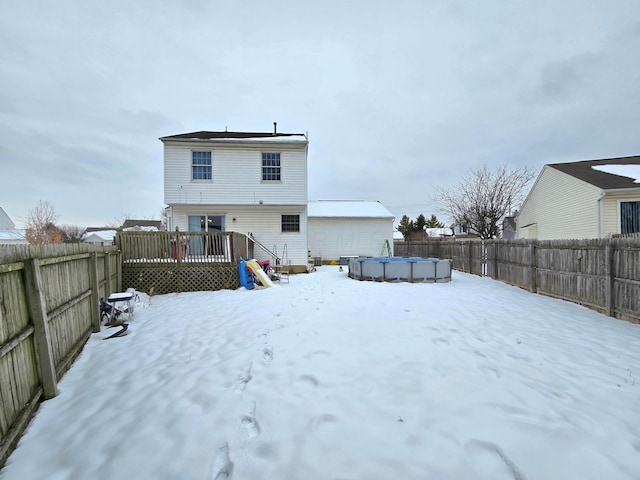 snow covered property with a pool side deck