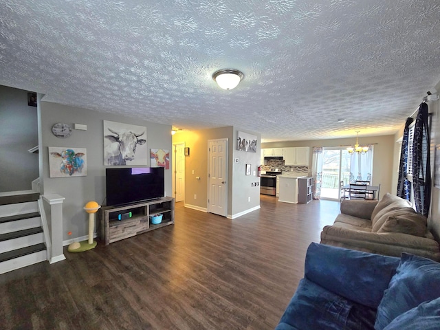 living room featuring a textured ceiling, a notable chandelier, and dark wood-type flooring