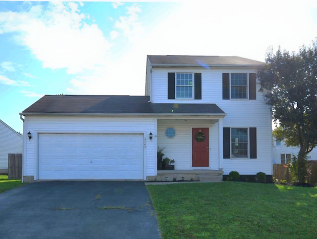 view of front of property with a front lawn and a garage