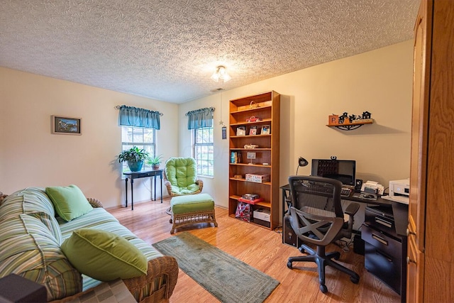 office with a textured ceiling and wood-type flooring