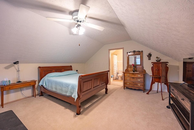 bedroom with a textured ceiling, ceiling fan, light carpet, and connected bathroom