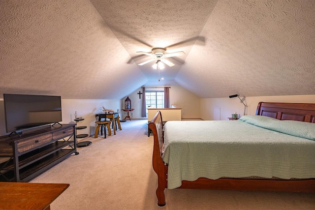 bedroom featuring carpet flooring, a textured ceiling, ceiling fan, and vaulted ceiling