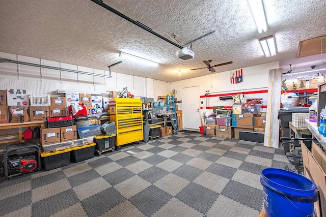 garage with a garage door opener and ceiling fan