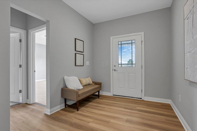 entrance foyer featuring light wood-type flooring and baseboards