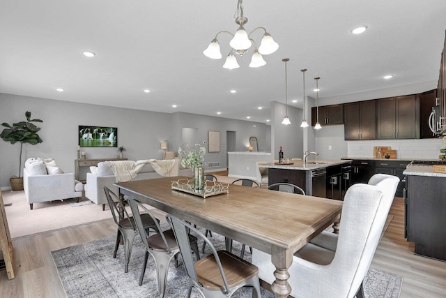 dining area featuring light wood finished floors, visible vents, an inviting chandelier, and recessed lighting