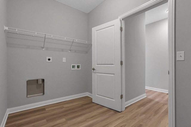 clothes washing area with laundry area, wood finished floors, electric dryer hookup, and baseboards