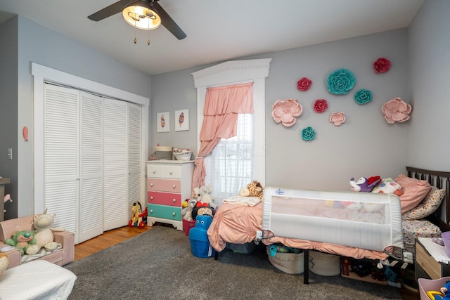 bedroom with wood-type flooring, ceiling fan, and a closet