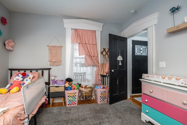 bedroom with dark colored carpet