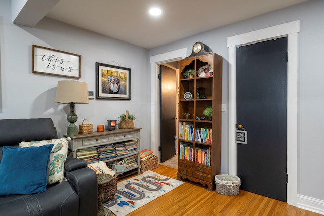 living area with hardwood / wood-style floors