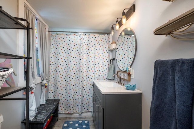 bathroom featuring curtained shower, vanity, and toilet