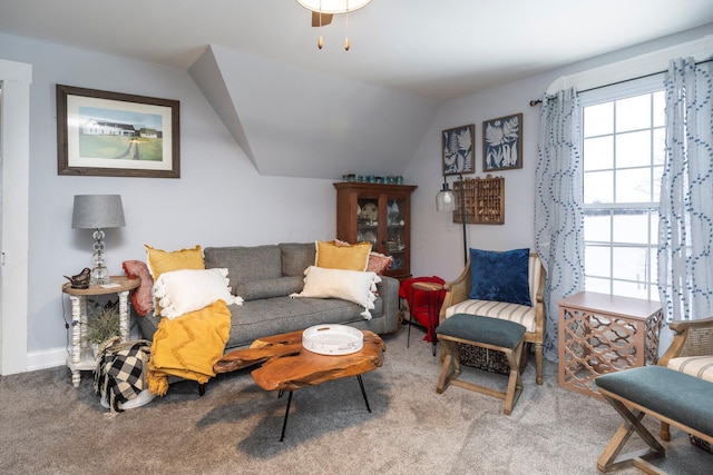 carpeted living room featuring lofted ceiling