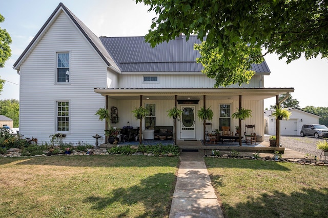 modern farmhouse style home with a porch, a front lawn, and a garage