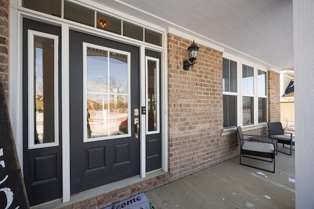 view of exterior entry with a porch