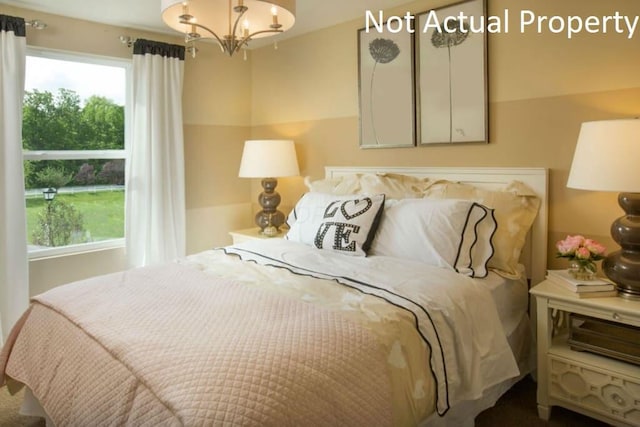 bedroom with a notable chandelier