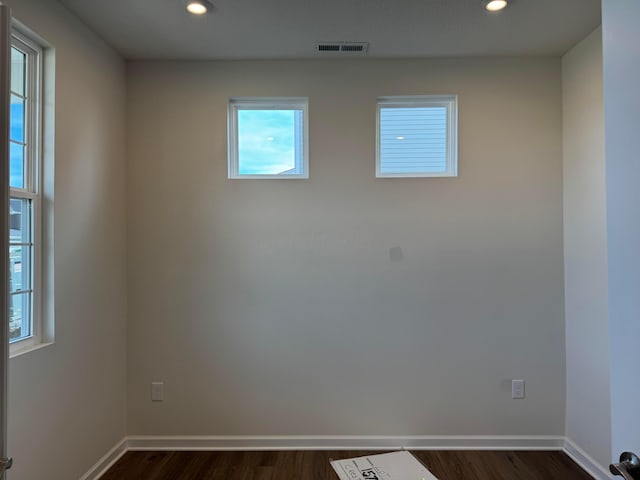 unfurnished room with dark hardwood / wood-style flooring