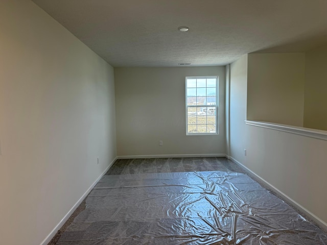 spare room with a textured ceiling