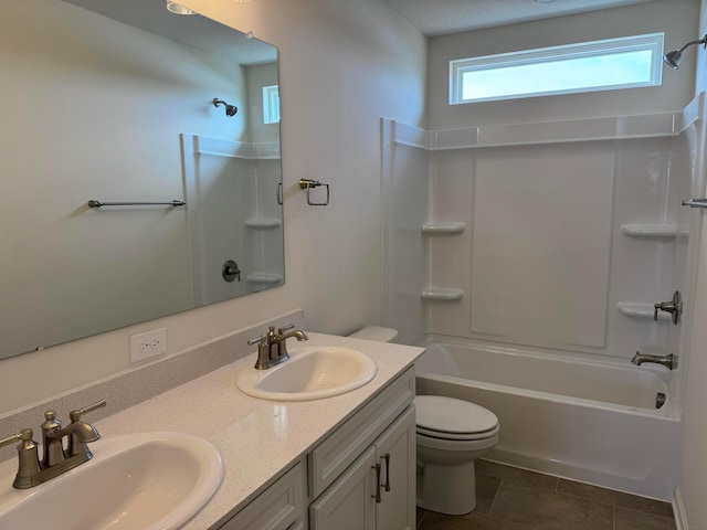 full bathroom featuring tile patterned flooring, vanity, bathtub / shower combination, and toilet