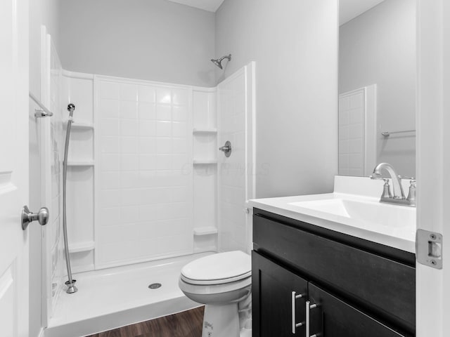 bathroom with toilet, walk in shower, wood-type flooring, and vanity