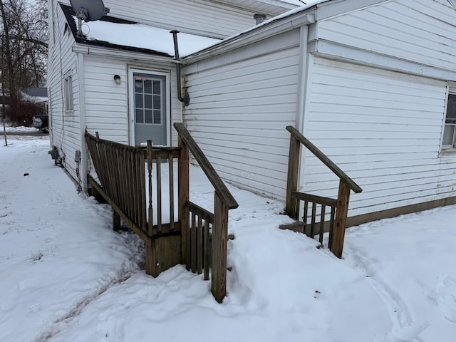 view of snow covered property entrance