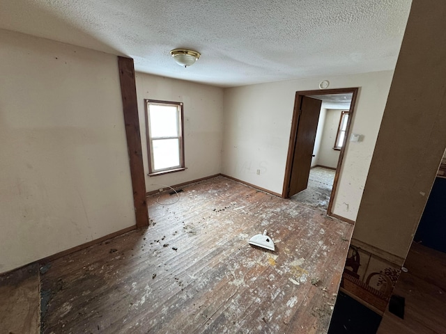 spare room with a textured ceiling