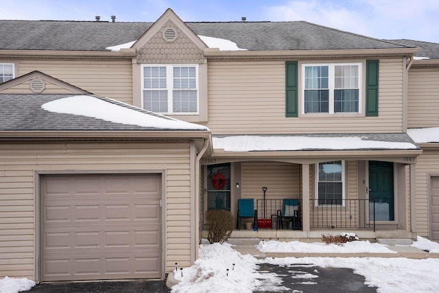 multi unit property with a garage and a porch