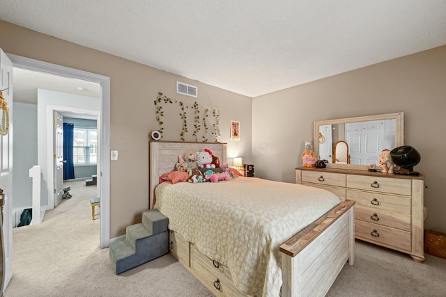 bedroom with visible vents, baseboards, and light colored carpet