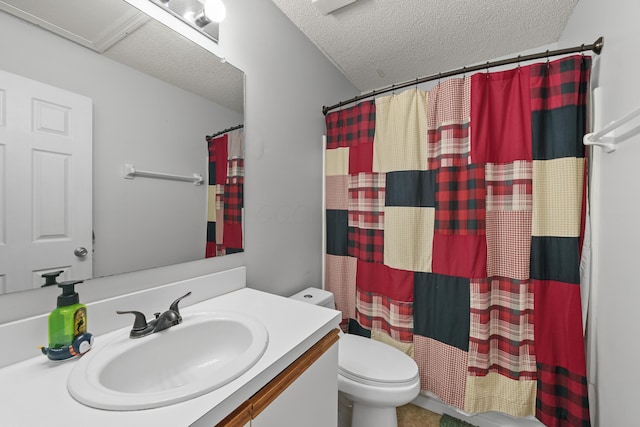 bathroom featuring vanity, toilet, and a textured ceiling