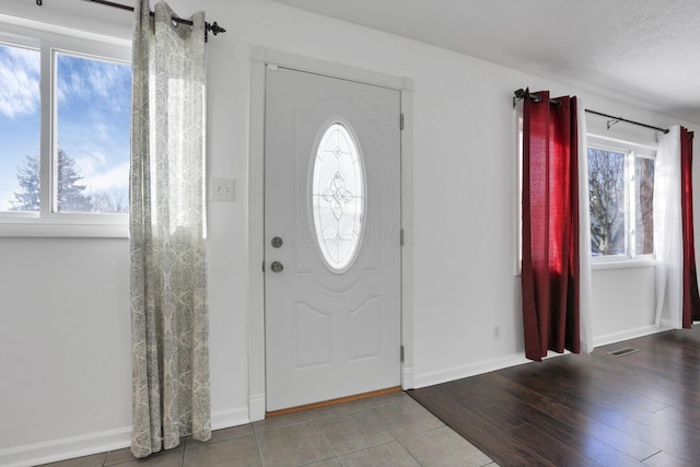 tiled entrance foyer with a textured ceiling