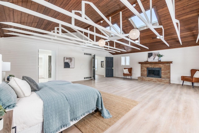 bedroom featuring wooden ceiling, a fireplace, wood-type flooring, and high vaulted ceiling