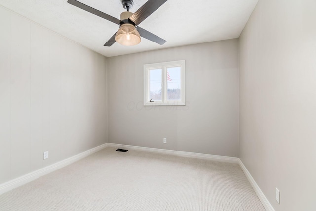 carpeted spare room with ceiling fan