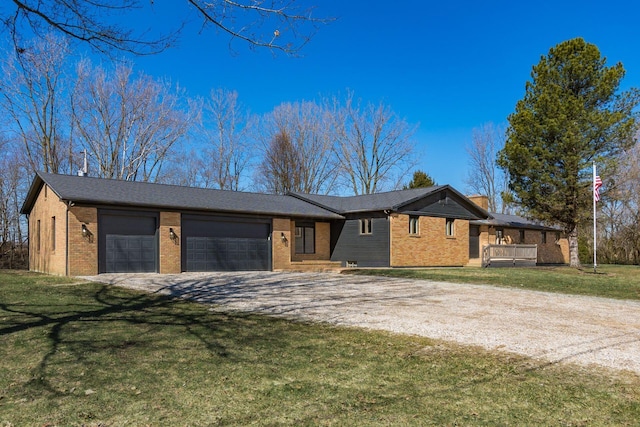 ranch-style home featuring brick siding, driveway, a front yard, and a garage