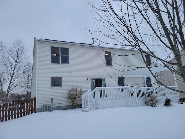 snow covered rear of property with cooling unit