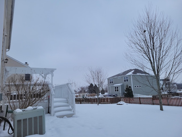 yard covered in snow with central air condition unit