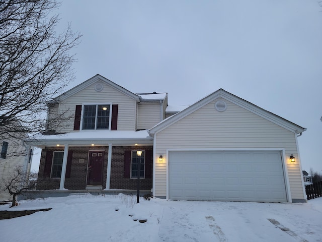 view of property featuring a garage and covered porch