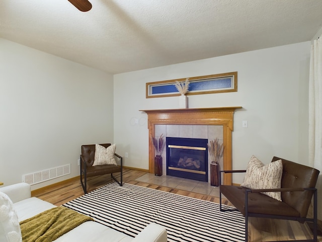 sitting room with light wood-type flooring and a fireplace