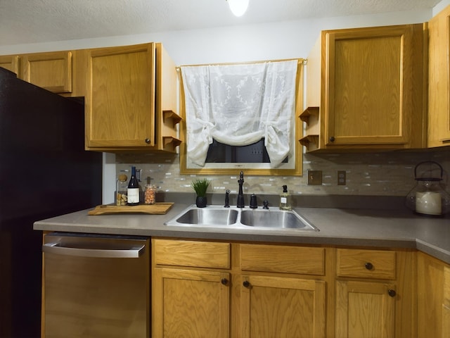 kitchen with backsplash, dishwasher, sink, and a textured ceiling