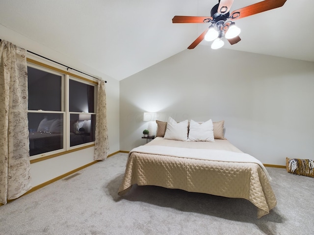 bedroom with ceiling fan, lofted ceiling, and carpet flooring